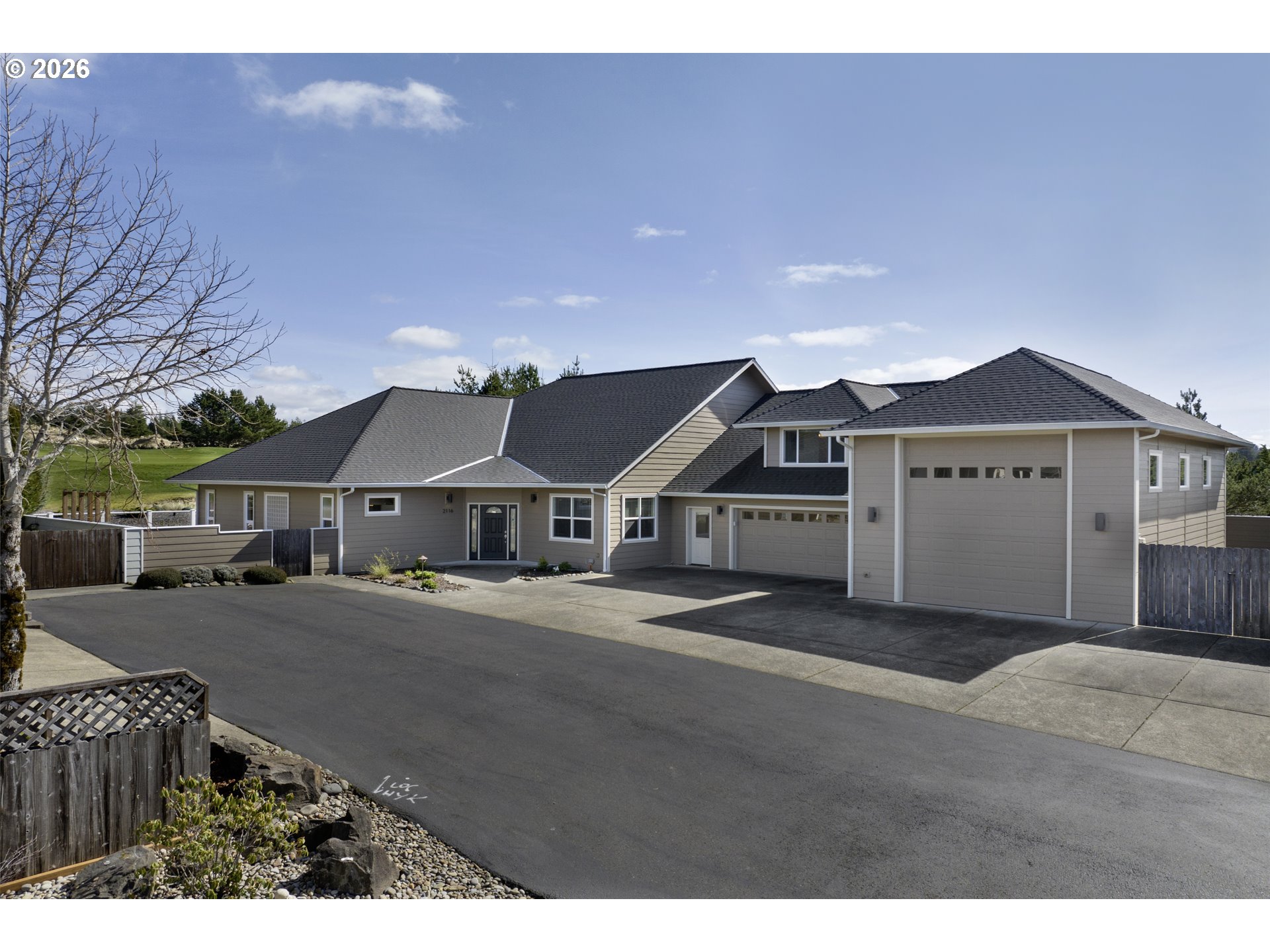 2116 Willow Loop East Florence, OR 97439 - Photo 1 of 47 a front view of a house with a yard and garage