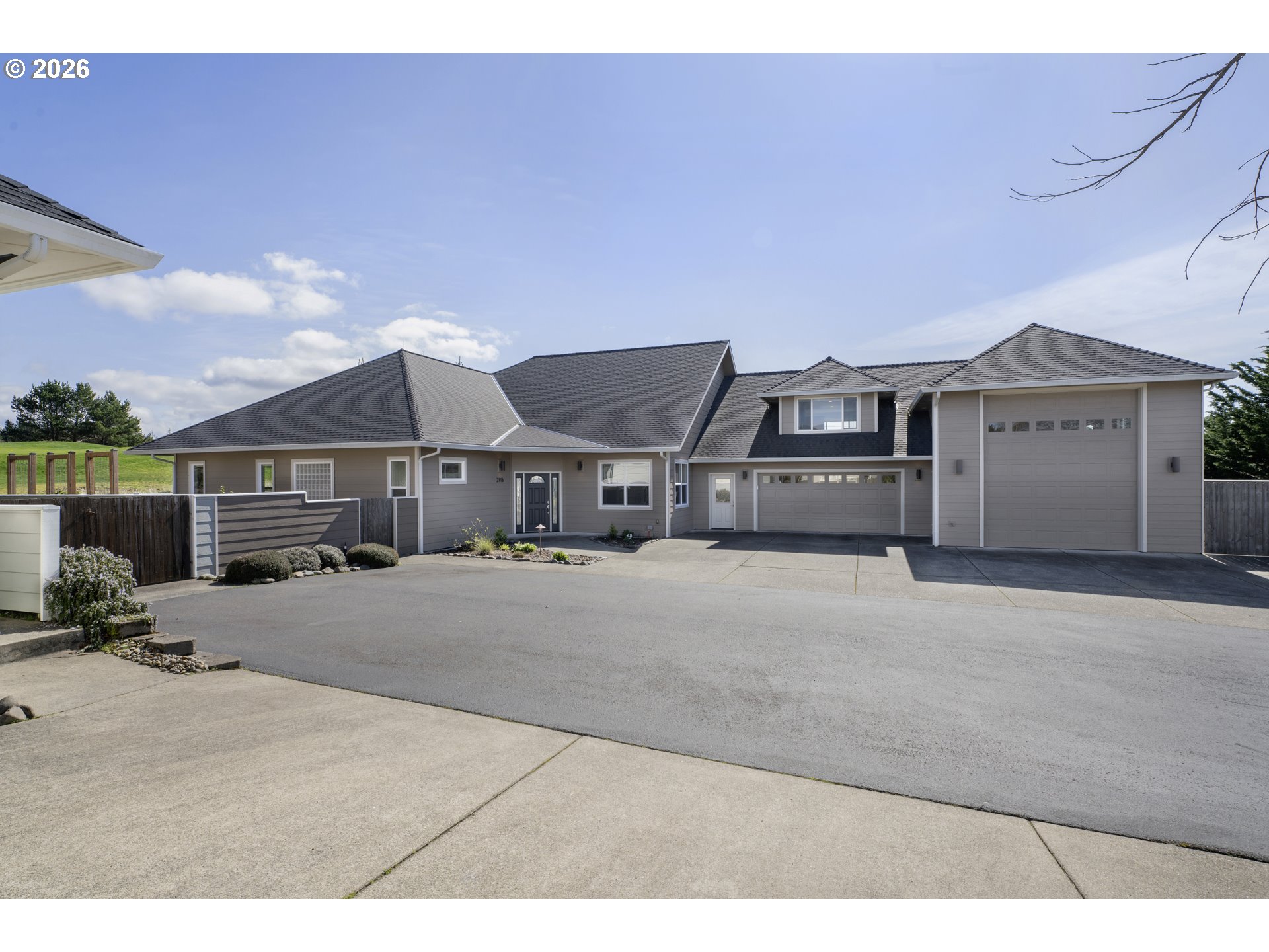 2116 Willow Loop East Florence, OR 97439 - Photo 2 of 47 a front view of a house with a yard