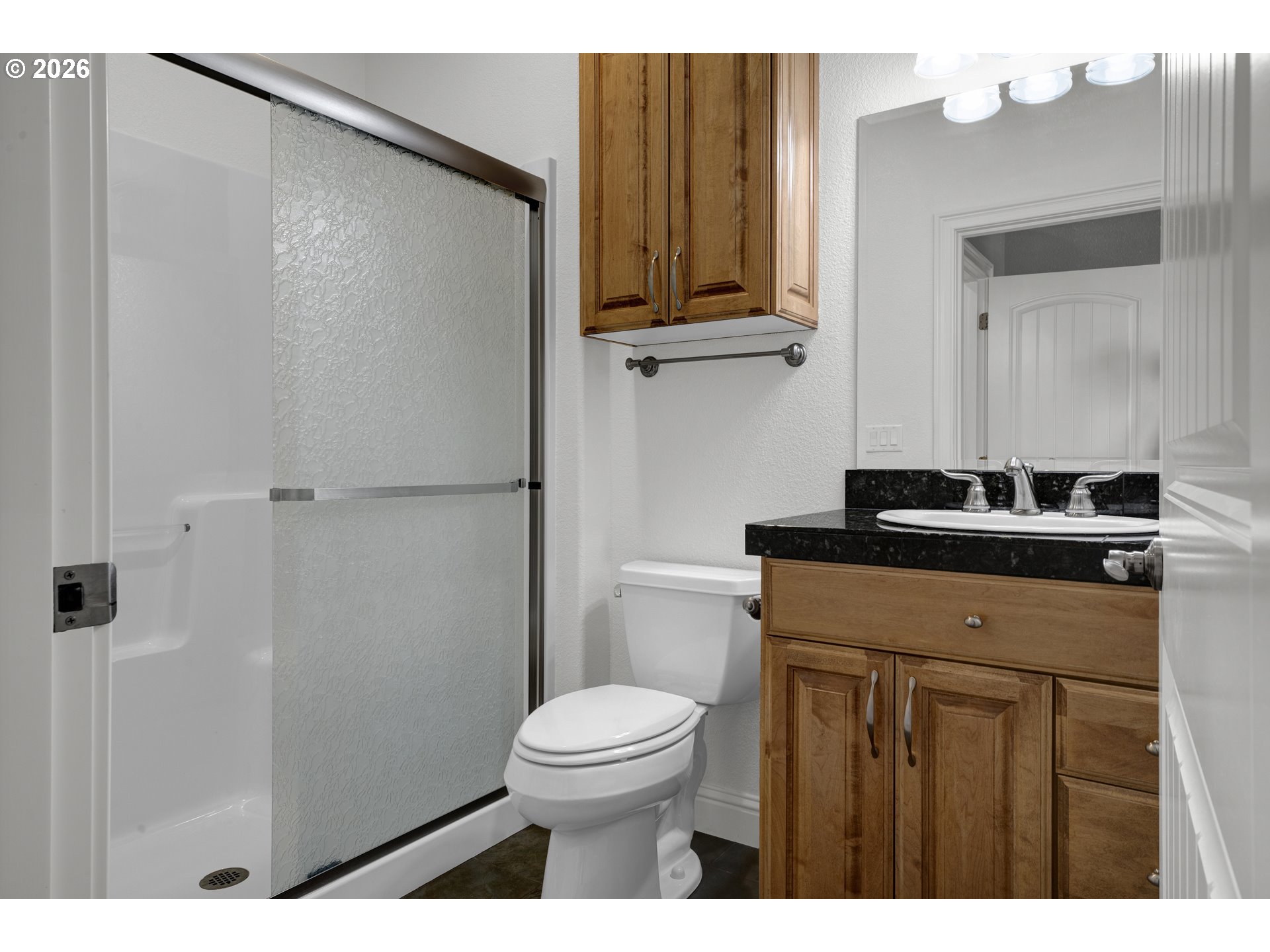 2116 Willow Loop East Florence, OR 97439 - Photo 26 of 47 a bathroom with a granite countertop sink toilet and shower