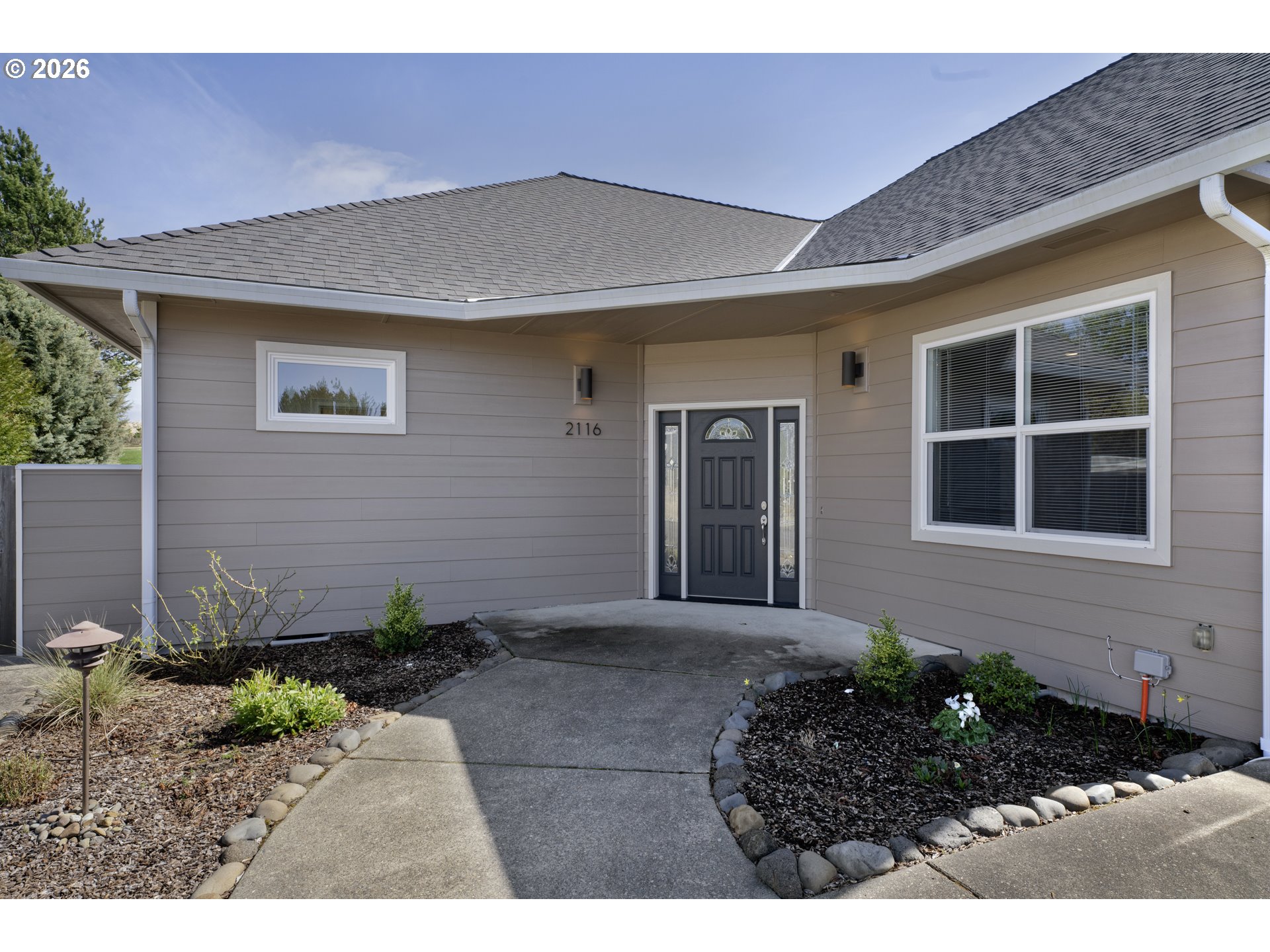 2116 Willow Loop East Florence, OR 97439 - Photo 5 of 47 a front view of a house with garden