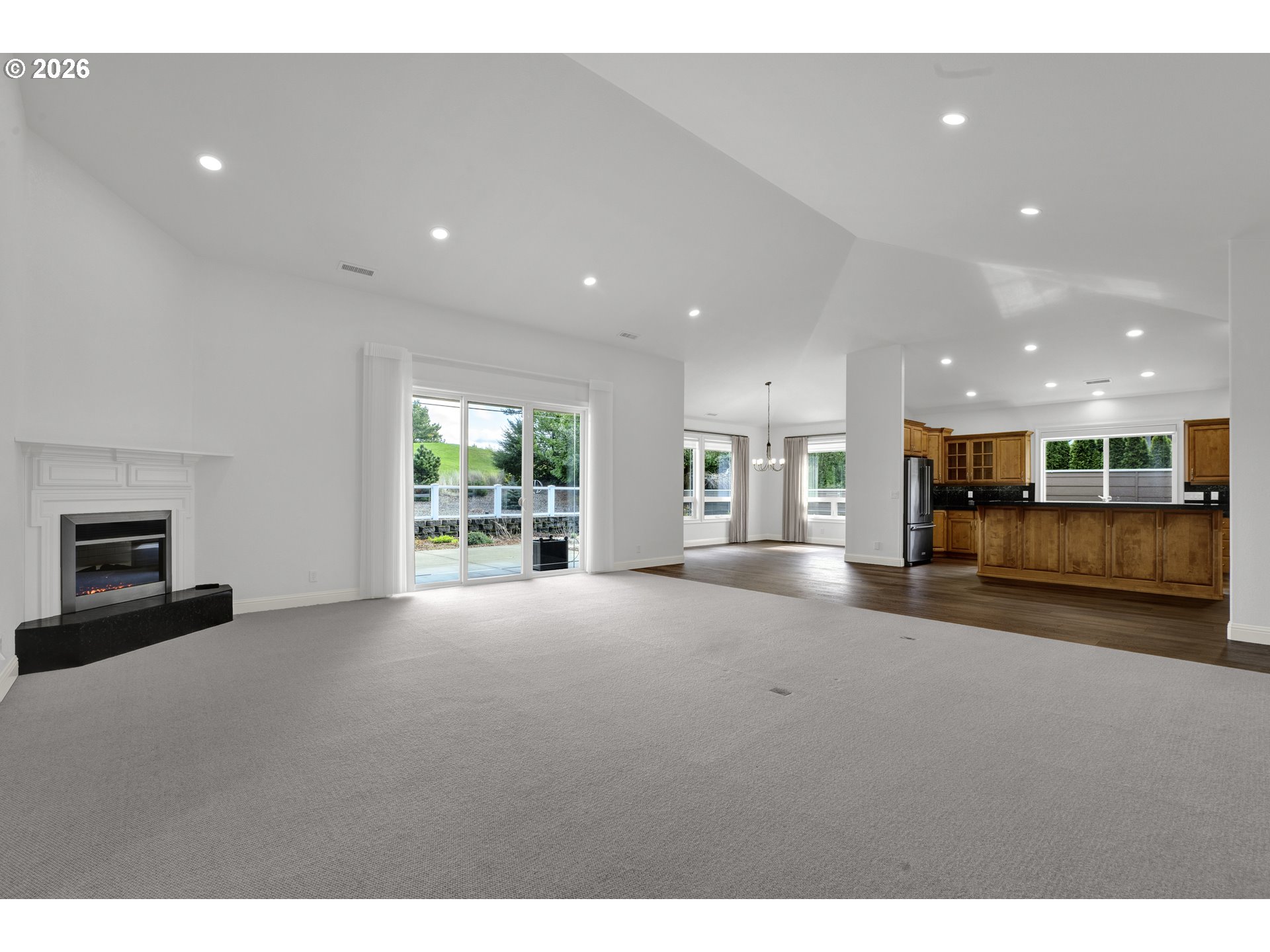 2116 Willow Loop East Florence, OR 97439 - Photo 8 of 47 a view of an empty room with a fireplace and a window