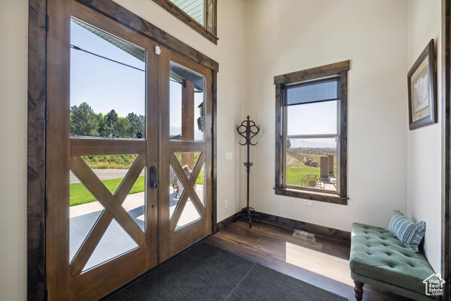 6117 North Rocky Ridge Road Peoa, UT 84061 - Photo 29 of 83 Foyer entrance with a wealth of natural light, dark hardwood / wood-style flooring, and french doors
