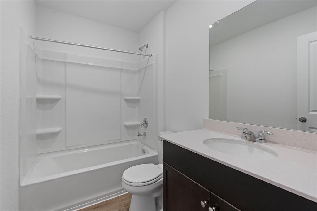 444 Marty Allen Loop Jarrell, TX 76537 - Photo 12 of 23 a bathroom with a sink a toilet and a bathtub