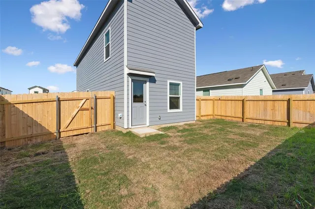 a view of a house with a backyard