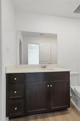 a bathroom with a sink vanity and mirror