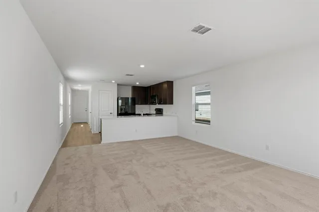 a view of a kitchen with a sink and cabinets