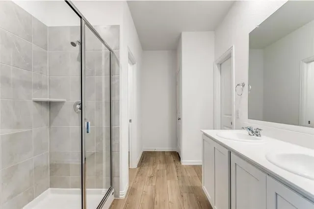 a view of a big room with windows and chandelier fan