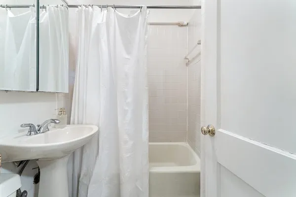 a bathroom with a sink a shower curtain and a sink