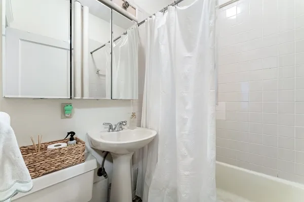 a bathroom with a sink a mirror and a shower