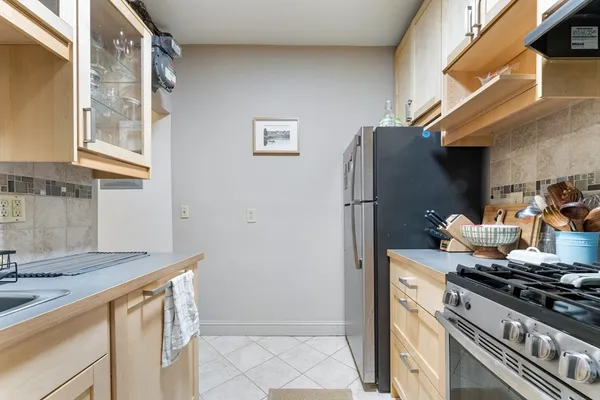 a kitchen with stainless steel appliances granite countertop a refrigerator and a sink