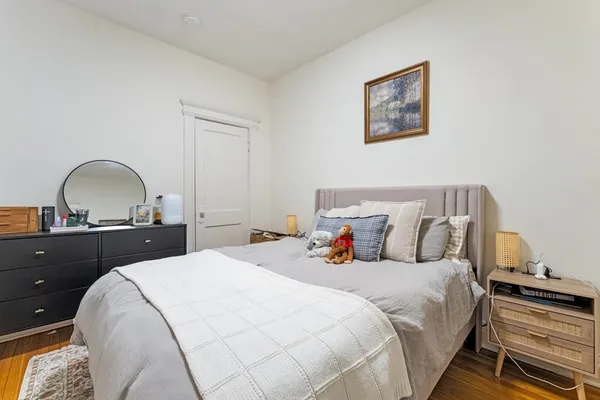 a bedroom with a bed and a dresser