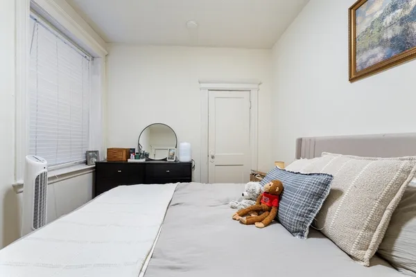 a bedroom with a bed and a dresser