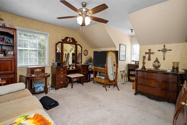 a spacious bathroom with a granite countertop sink a large mirror and a bathtub