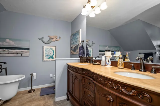 a bathroom with a sink a mirror and a window