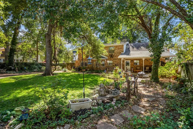 a view of a patio with chairs and table in a yard