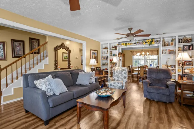 a living room with furniture fireplace and a large window