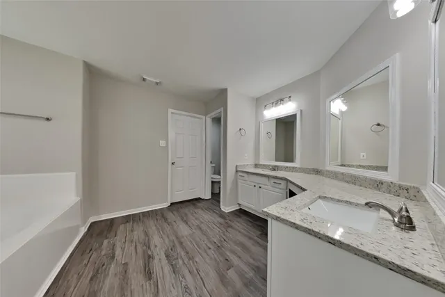 a bathroom with a granite countertop sink mirror and vanity