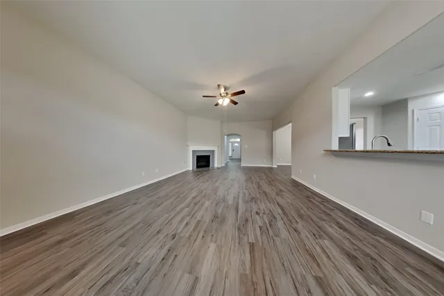 a view of a kitchen with wooden floor and a sink