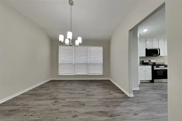 a view of a kitchen with stove and cabinets