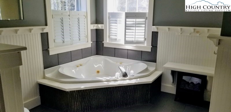 1371 West Buffalo Road West Jefferson, NC 28694 - Photo 4 of 31 a bath tub sitting in a bathroom next to a window