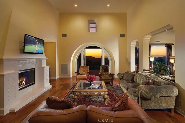 a living room with furniture fireplace and flat screen tv