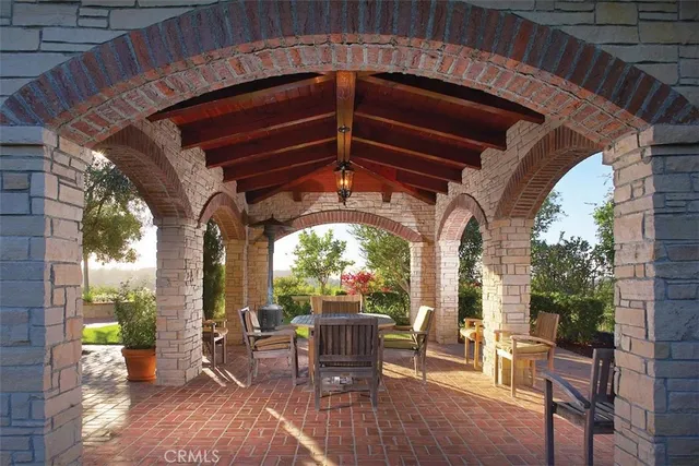 a view of a porch with furniture and a yard