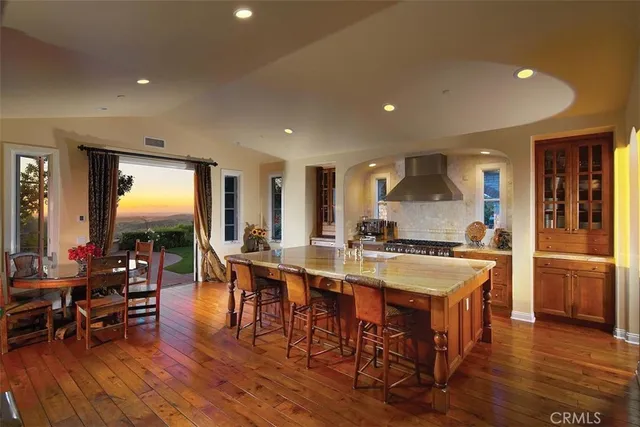a large kitchen with a table and chairs