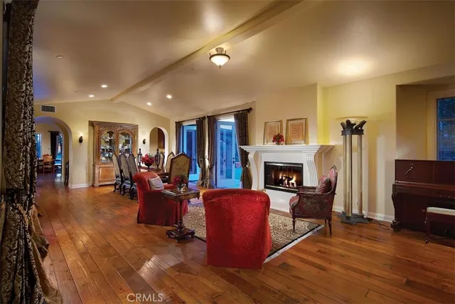 a living room with furniture a fireplace and a piano