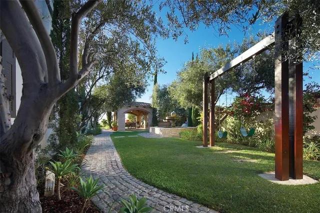 a view of a yard with plants and trees