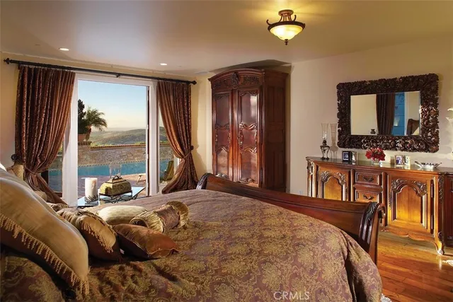 a bed room with a bed window and a chandelier