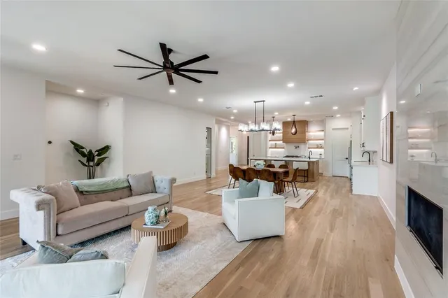a living room with furniture kitchen view and a potted plant