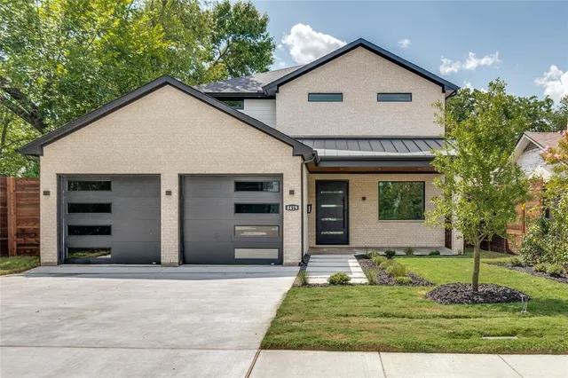 a view of a house with a yard and garage