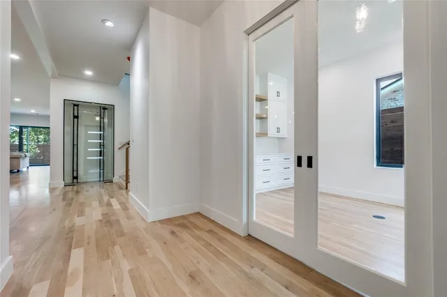 wooden floor in an empty room with a bathroom