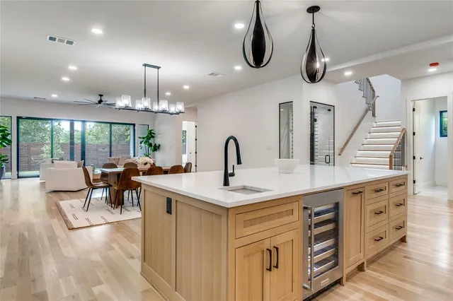 a view of a backyard with large tree and wooden fence