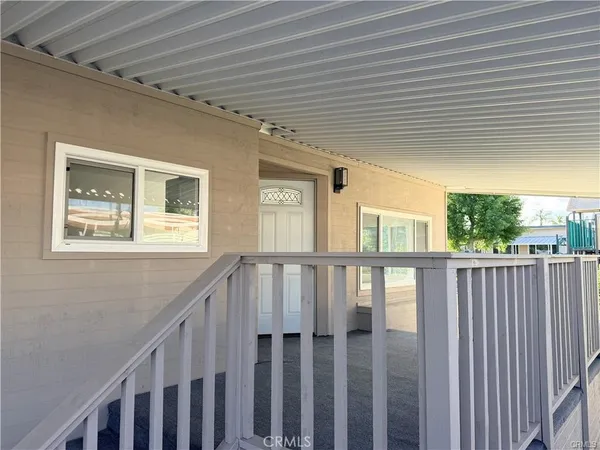 a view of a porch with wooden floor