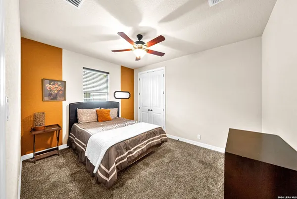 a bathroom with a sink a toilet a mirror and shower