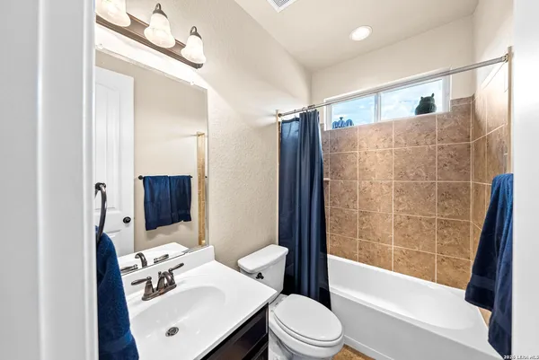 a bedroom with a bed flat screen tv and a large window