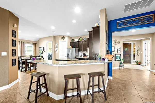 a kitchen with a sink refrigerator and cabinets