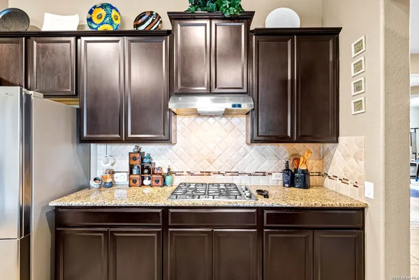 a view of a kitchen with kitchen island granite countertop a sink and a large window