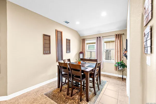 a view of a dinning table and chairs in the patio