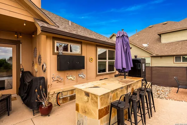 a view of a patio with a table and chairs