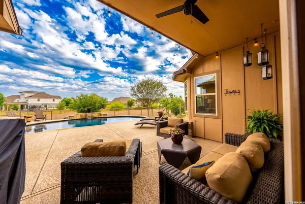 a view of a house with pool and chairs