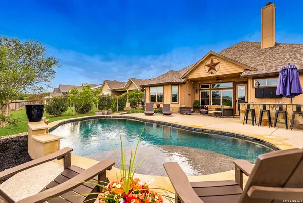a view of swimming pool with outdoor seating and plants