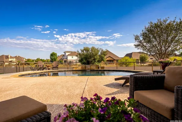 a swimming pool with outdoor seating and yard