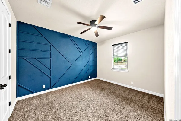 a bedroom with a bed and a ceiling fan