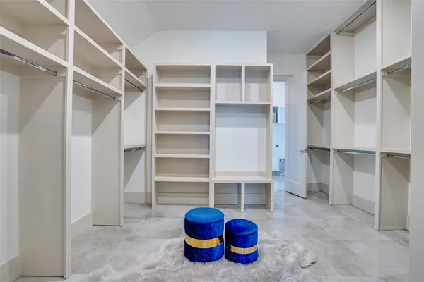 a view of walk in closet with empty racks