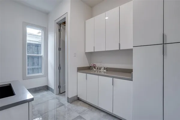 a kitchen with granite countertop a sink a stove and cabinets