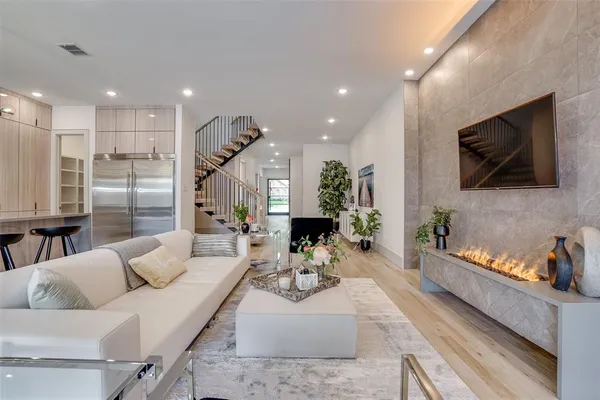 a living room with furniture and a chandelier