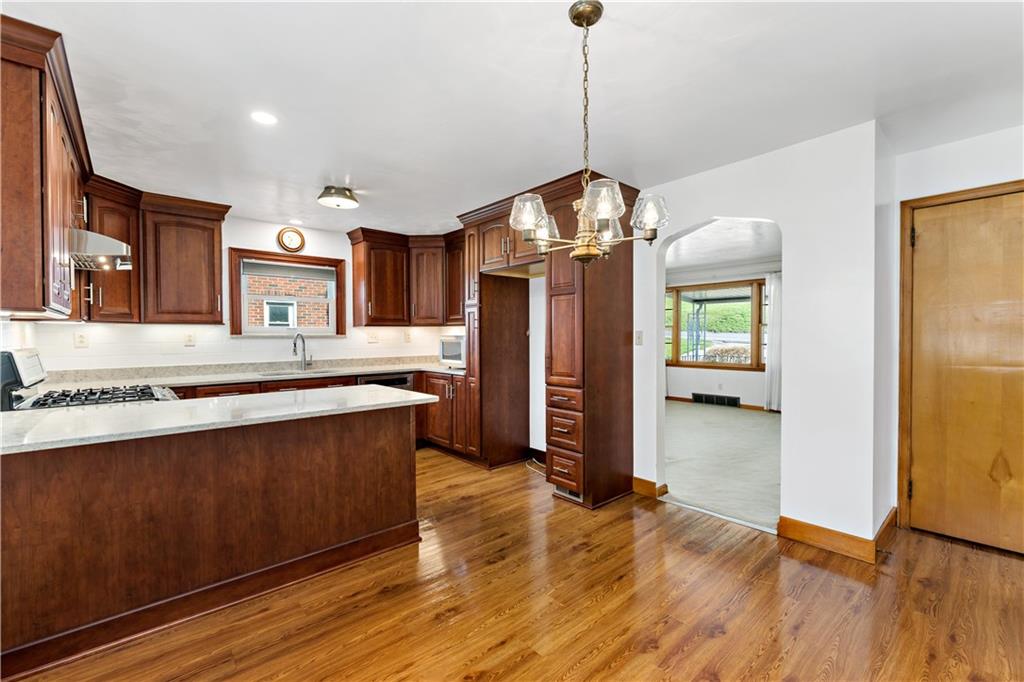 220 McClelland Road Canonsburg, PA 15317 - Photo 6 of 38 a large kitchen with stainless steel appliances granite countertop a refrigerator a oven a island and a wooden floor