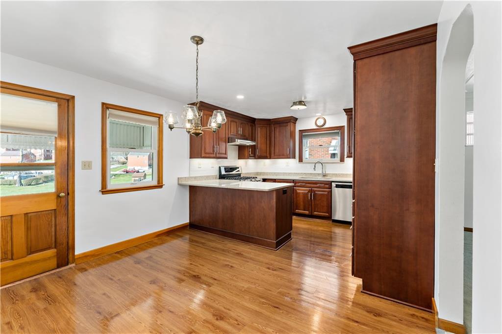 220 McClelland Road Canonsburg, PA 15317 - Photo 9 of 38 a kitchen with stainless steel appliances granite countertop a refrigerator a sink dishwasher a oven with wooden cabinets and wooden floor